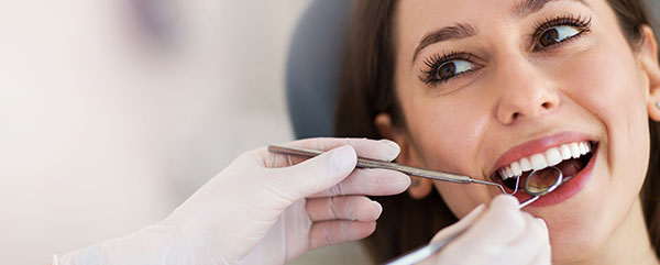 A happy patient receiving a dental examination.