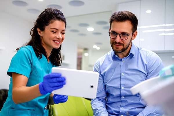 A dental provider talking with a patient