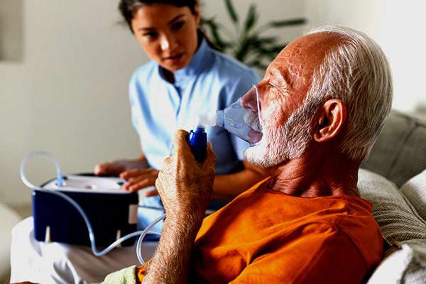 Senior Man With Chronic Bronchitis is Using Inhaler.